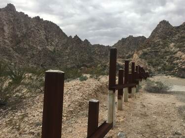 Sierra El Choclo Duro and Mexico/US border.  Steel posts block vehicles, but not animals or humans on foot.